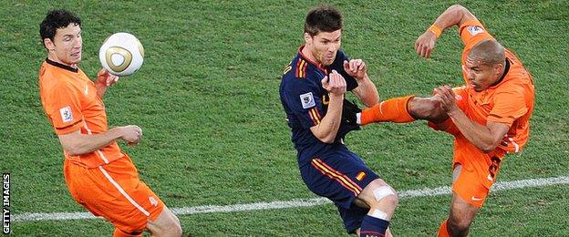 Nigel De Jong escaped with a yellow card for this tackle on Xabi Alonso