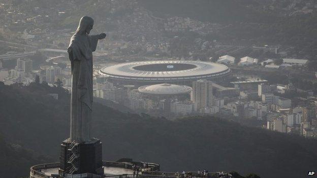 An aerial view shot of the Maracana stadium behind the Christ the Redeemer statue in Rio de Janeiro