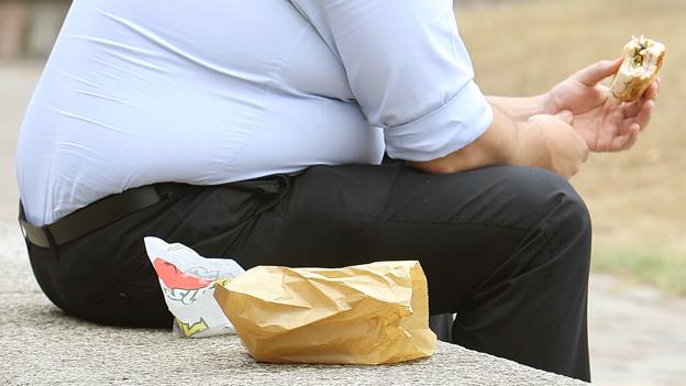 big man eating burger