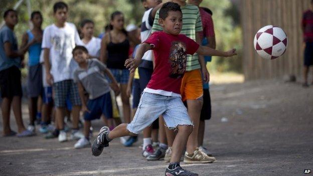 A child kicks a football ball during practice in Tegucigalpa, Honduras, on 7 March, 2014