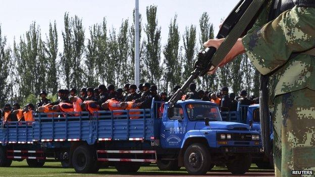 Criminals and suspects are transported to a stadium for a mass sentencing rally in Yili, Xinjiang Uighur Autonomous Region, 27 May 2014