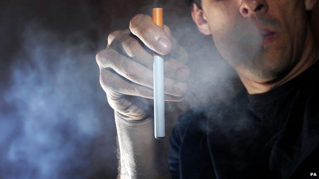 A man smokes an electronic cigarette