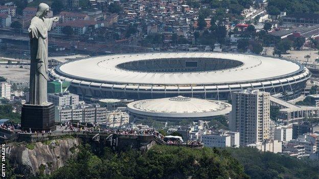 Aerial view of the Christ the Redeemer statue atop Corcovado Hill and the Mario Filho (Maracana) stadium in Rio de Janeiro, Brazil, on December 3, 2013. The Maracana stadium will host the Brazil 2014.