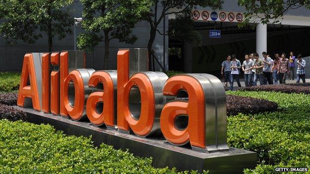 Workers walk out from the Alibaba head office building in Hangzhou, eastern China