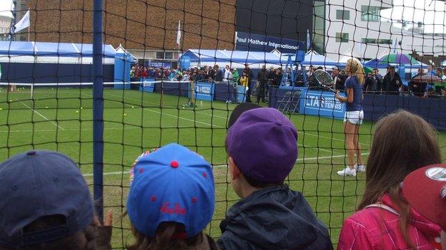 Children watching Agnieszka Radwanska practice in 2013