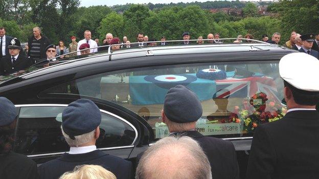 Hearse carrying coffin draped in RAF flag