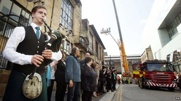 Piper playing as firefighters leave