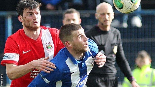 Linfield's Philip Lowry puts pressure on his older brother Stephen