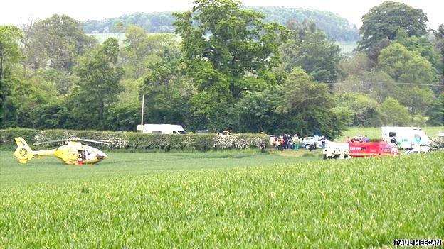 An air ambulance landing at the scene of the crash