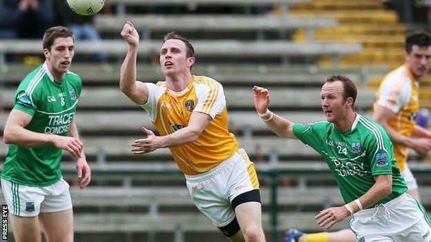 Antrim's Michael McCann in possession against Eoin Donnelly and Paul Ward of Fermanagh