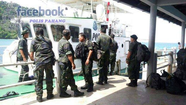 Malaysian Police officers engaged in the search