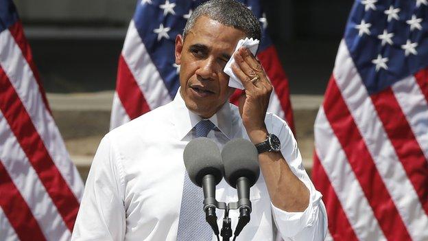 President Barack Obama wipes perspiration from his face as he speaks about climate change at Georgetown University in Washington on 25 June 2013