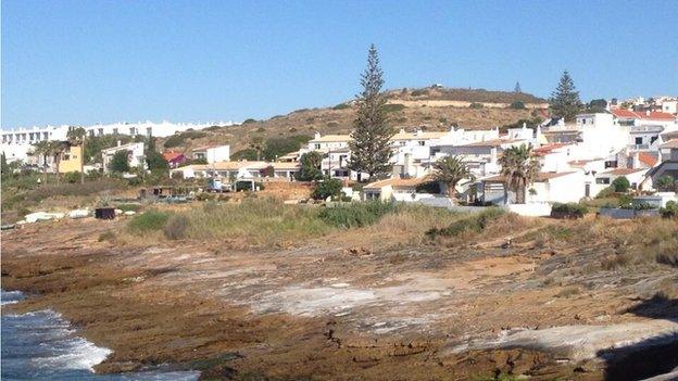 Praia da Luza - police van on top of hill in background is part of search in police investigation into disappearance of Madeleine McCann