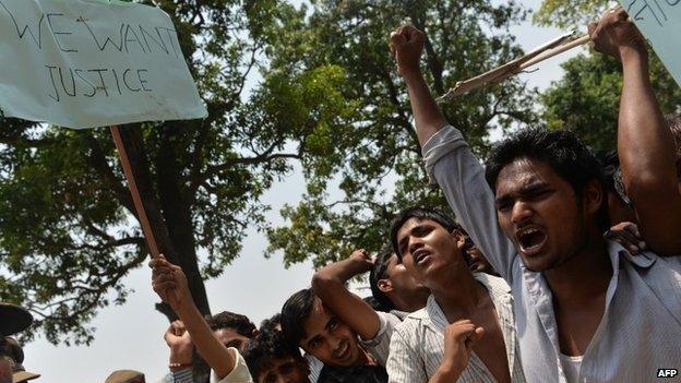 Indian demonstrators carry placards and shout slogans as they protest against the Chief Minister of the state of Uttar Pradesh Akhilesh Yadav in Katrashadatganj in Badaun district of Uttar Pradesh state on June 1, 2014.