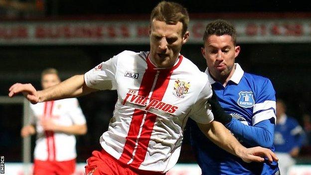 Stevenage's Luke Jones (left) in action against Everton's Bryan Oviedo