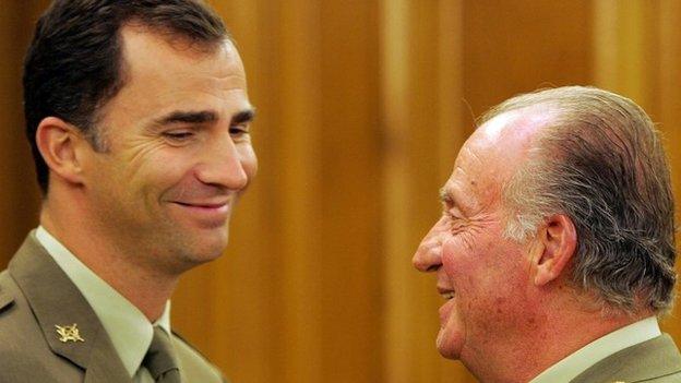 A file photo taken on October 11, 2005 shows Spain's King Juan Carlos (R) chatting with his son Prince Felipe