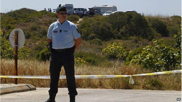 A Portuguese police officer guarding a cordon of police tape