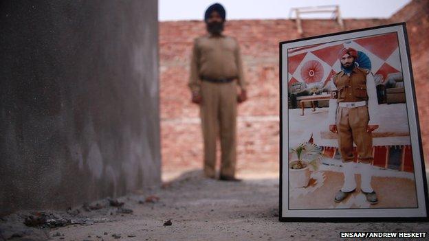 Satwant Singh Manak with a picture of himself in his uniform