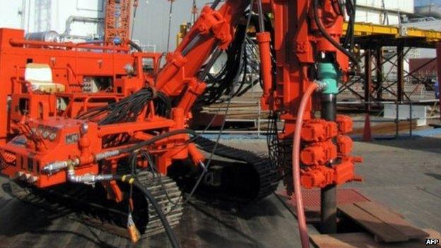 An excavator drills in the ground at Tepco's Fukushima Daiichi nuclear power plant at Okuma in Fukushima prefecture, Japan, 2 June 2014