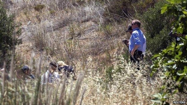 Police searching an area of scrubland in Praia da Luz