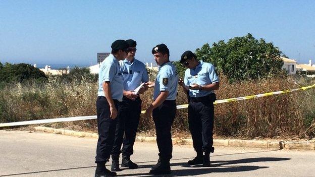 Officers standing outside the cordoned off section of scrubland