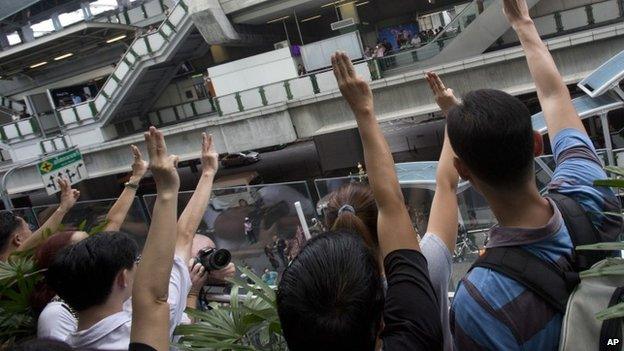 Anti-coup protesters flash three-fingered in central Bangkok on 1 June 2014