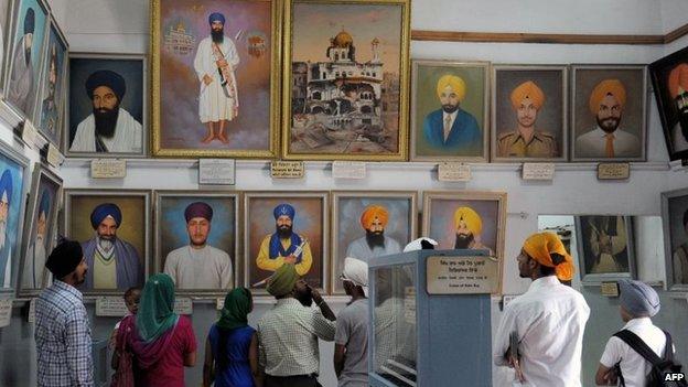 Visitors look at photographs of slain Sikh fighters, killed during Operation Blue Star in 1984, at a museum inside the Golden Temple complex