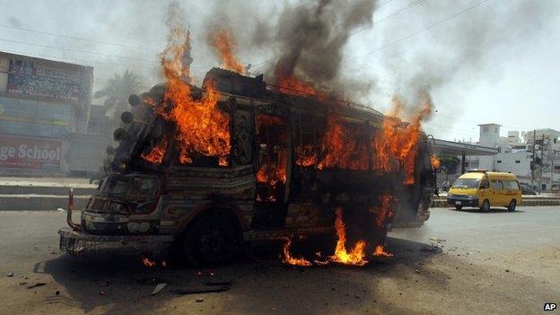 A bus burns after being set on fire by protesters condemning the arrest in London of Altaf Hussain, who heads the Muttahida Qaumi Movement, or MQM, one of Pakistan's major political parties, in Karachi, Pakistan, Tuesday, June 3, 2014