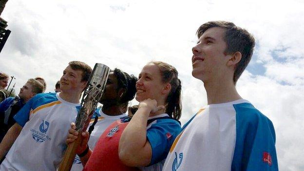 Torch bearers stand side by side in Bristol