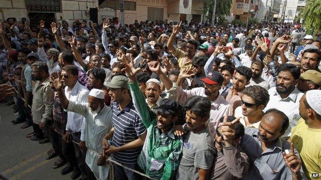 Supporters of the Muttahida Qaumi Movement, or MQM, one of Pakistan's major political parties, shout slogans condemning the arrest in London of its leader, Altaf Hussain, in Karachi, Pakistan, Tuesday, June 3, 2014.