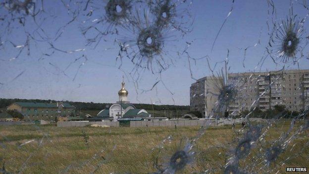 A Ukrainian border command centre is seen through bullet holes in a lorry's windscreen near Luhansk. Photo: 3 May 2014