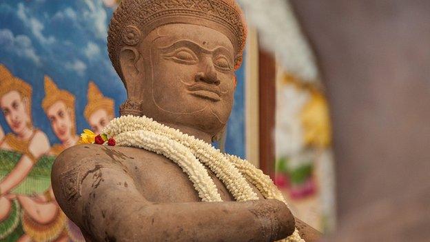 A traditional crown of flowers sits on the neck of the Bhima statue returned by the Norton Simon Museum to Cambodia during a handover ceremony at the Council of Ministers on 3 June, 2014 in Phnom Penh, Cambodia