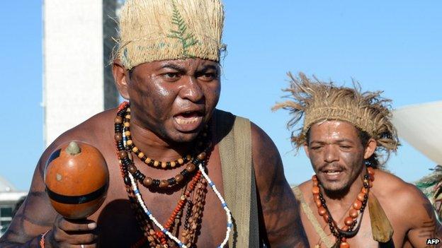 Brazilian natives from different ethnic groups dance during a protest in front of the National Congress as part of Indigenous Mobilization Week, in Brasilia on 28 May 2014