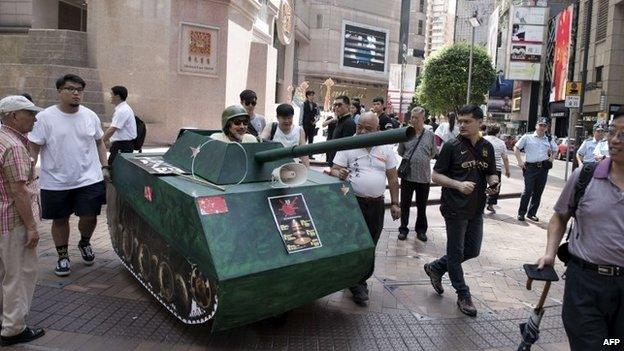 Activists walk with a replica of a Chinese tank in Hong Kong to commemorate the 1989 Tiananmen Square military crackdown in Beijing on pro-democracy protesters, on June 4