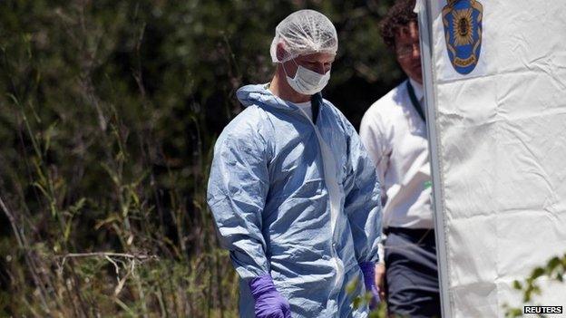 Forensic officer outside a white tent