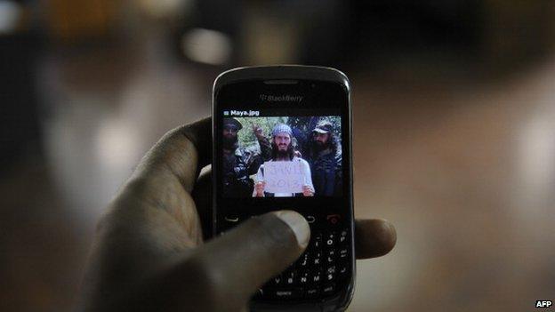 An undated photo of al-Amriki taken at an undisclosed location is seen on a mobile phone screen in Nairobi, Kenya in February 2013