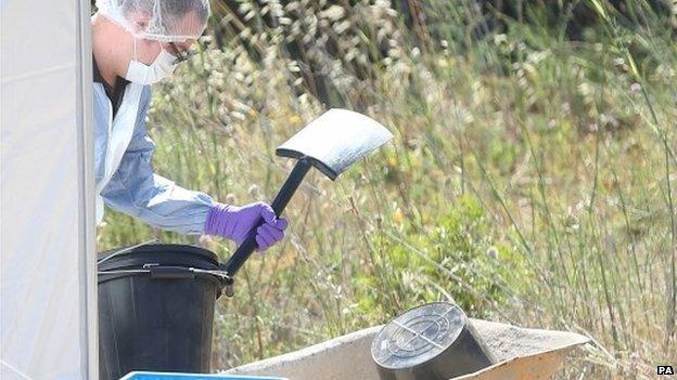 Forensic officer outside a white tent