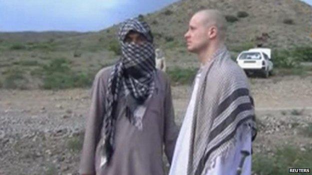 US Army Sergeant Bowe Bergdahl (right) waits before being released at the Afghan border