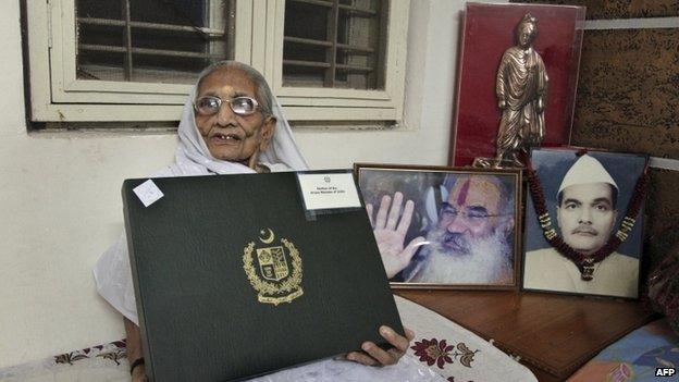 Hiraben, mother of India's prime minister Narendra Modi, displays a box with a white sari inside gifted to her by Pakistani Prime Minister Nawaz Sharif in Gandhinagar, India, Thursday, June 5, 2014.