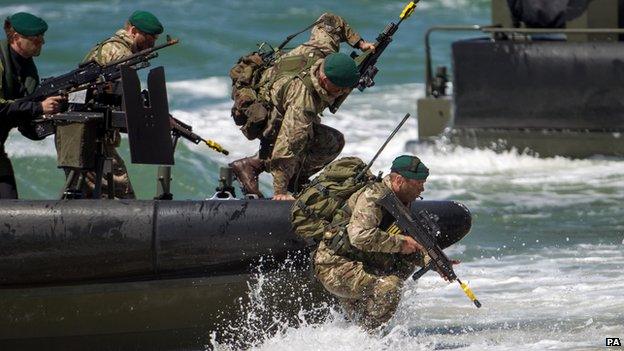 Soldiers running off an amphibious vehicle