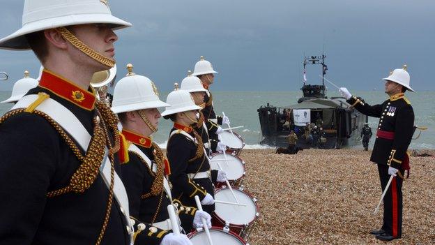 A band from the Royal Marines School of Music plays to welcome a team of Royal Marines as they arrive at Southsea