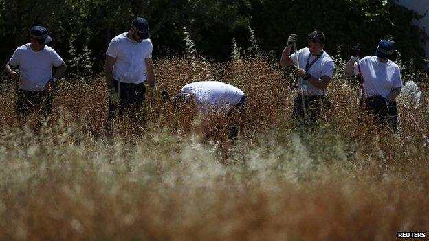 Members of Scotland Yard at the search area