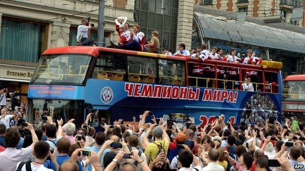 People greet buses carrying Russia's ice hockey team in Moscow