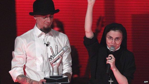 Sister Cristina Scuccia receives the winner's trophy. 6 June 2014