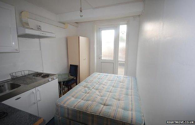 Tiny studio flat with bed and kitchen units