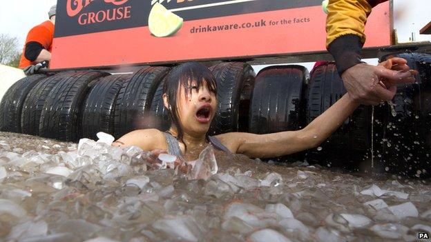 A female participant in a Tough Mudder event