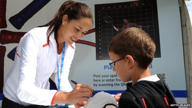 Ana Ivanovic signing an autograph for a boy in 2012