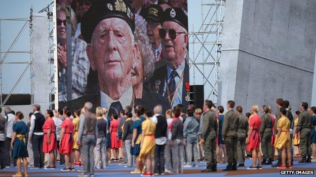 A screen at the Sword Beach ceremony