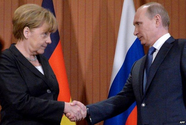 German Chancellor Angela Merkel (left) shakes hands with Russian President Vladimir Putin during a meeting at the Normandy Barriere hotel in Deauville on 6 June 2014.