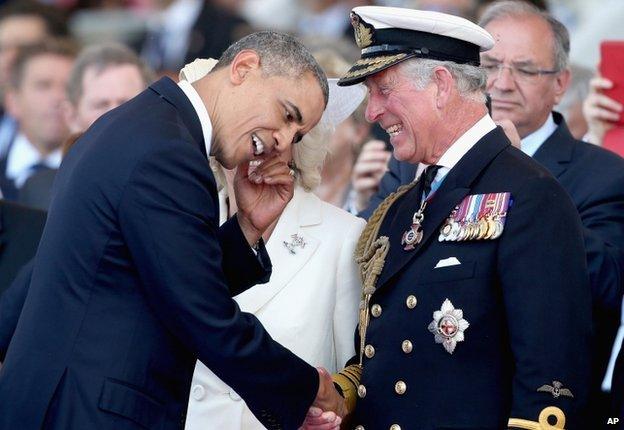 Britain's Prince Charles, right, laughs as he meets US President Barak Obama,